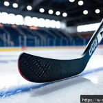 아이스하키 스틱 고르는 법 - A modern composite hockey stick leaning against the boards of an ice rink, featuring detailed textur...